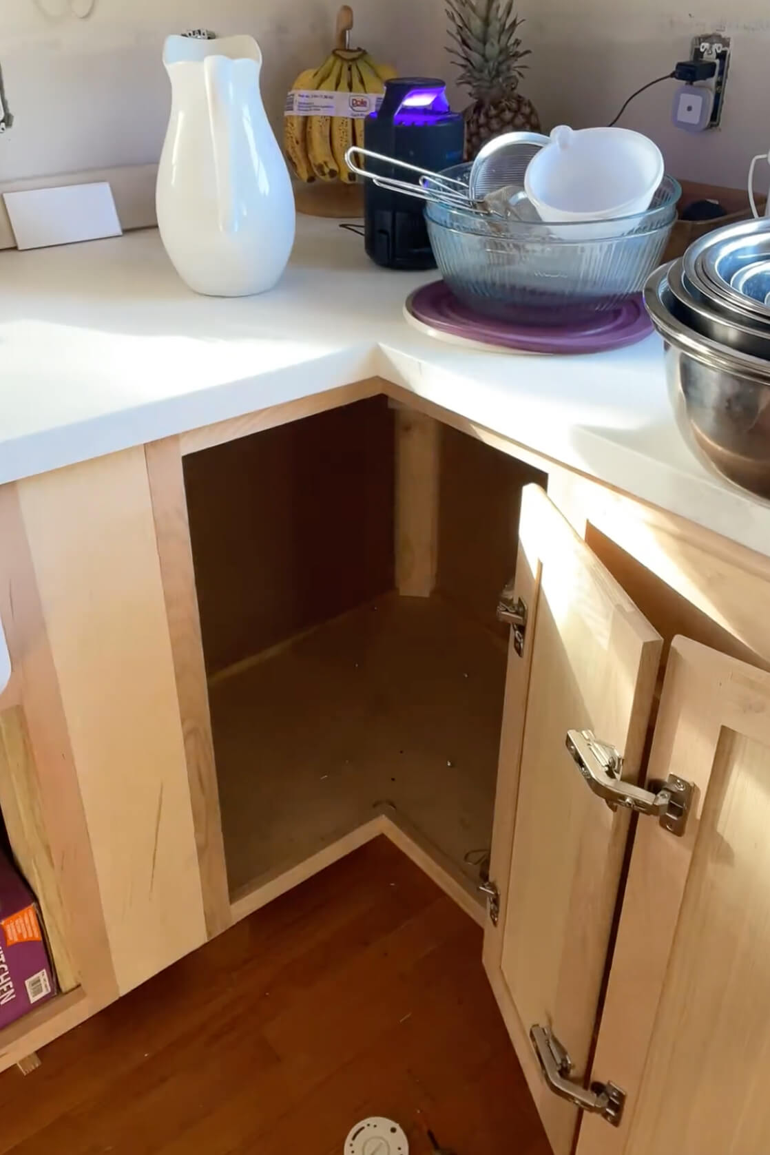 Empty kitchen cabinet after removing a Lazy Susan.